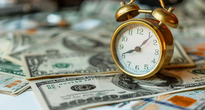 Cozy kitchen scene with a person reviewing payday loan documents on a laptop