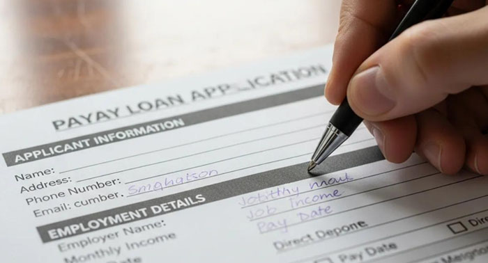 Hand filling out payday loan application form, illustrating the application process